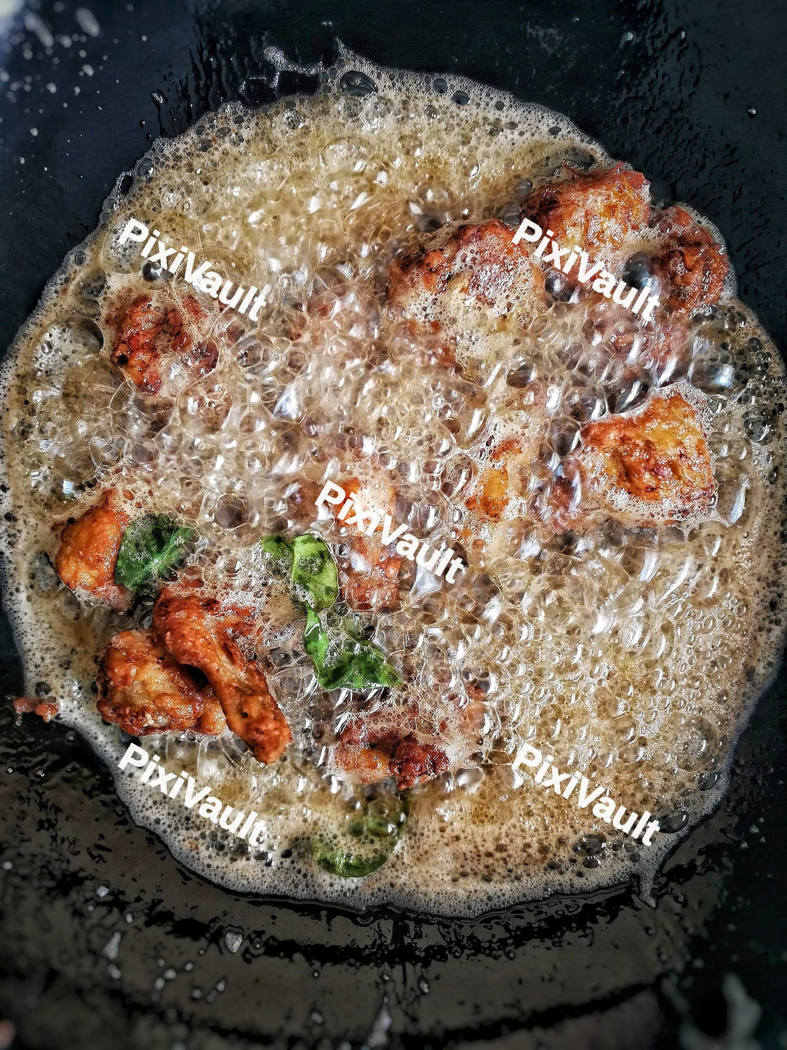 Fried chicken wings in the boiling oil